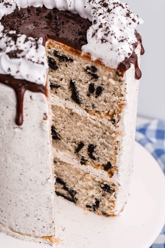 The full Oreo Layer Cake with a piece of removed sowing each individual layer.