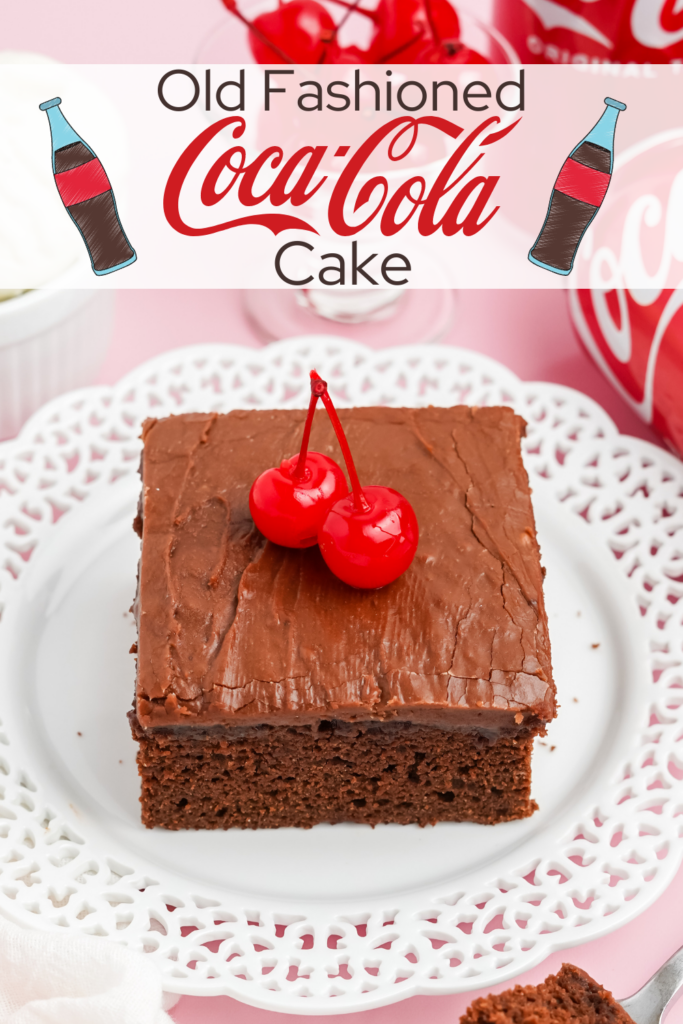 A square piece of coca cola cake on a white plate with two maraschino cherries on top. A can of coca cola peaking in on the side on a pink background.