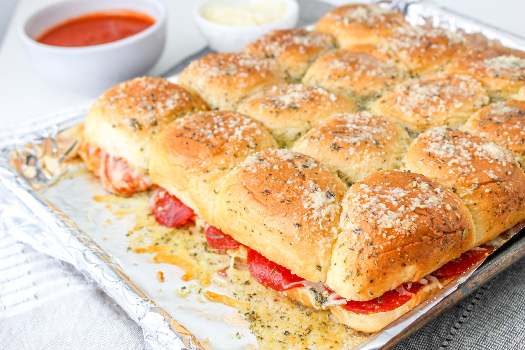 Pepperoni Pizza Sliders in a foil lined baking dish 