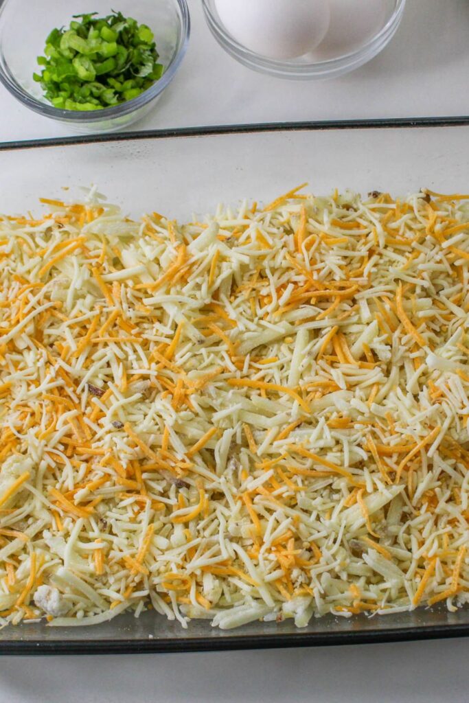 cheeese on top of hashbrowns in casserole pan