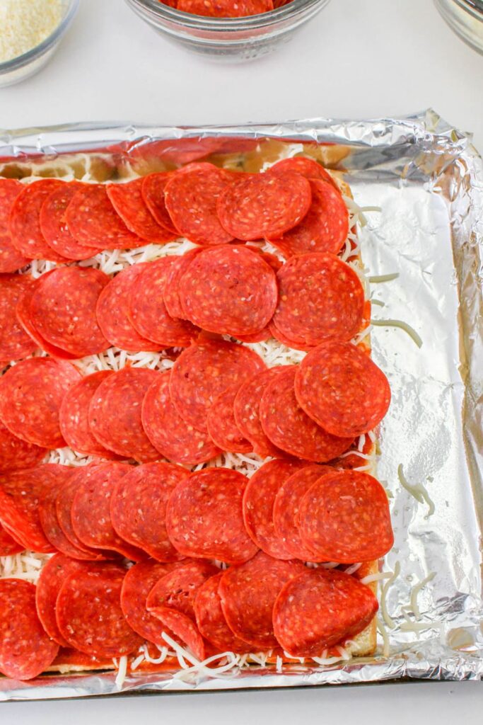 rows of pepperoni topped on rolls