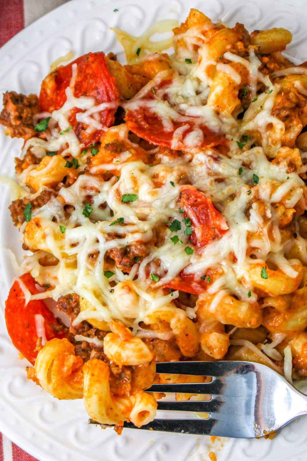 plate with slow cooker pizza casserole on it with fork on side