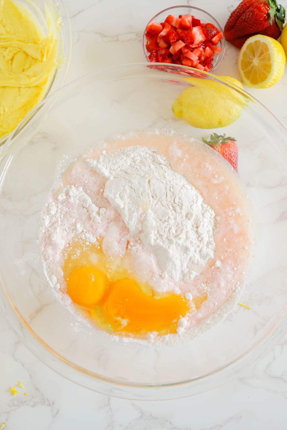 strawberry cake batter in bowl with water and eggs 