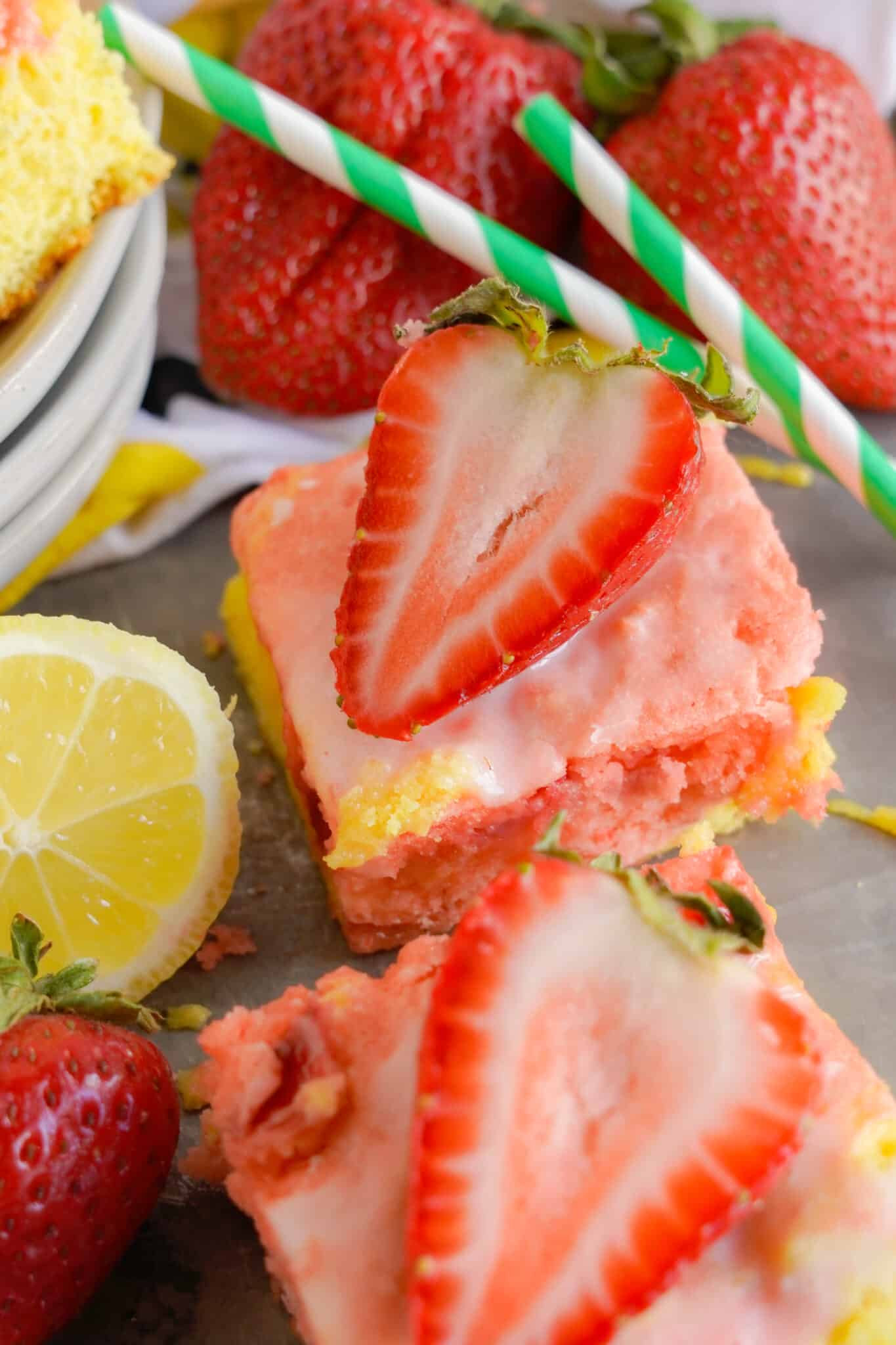 strawberry Lemon Blondies on a table with a strawberry and sliced lemon next to them