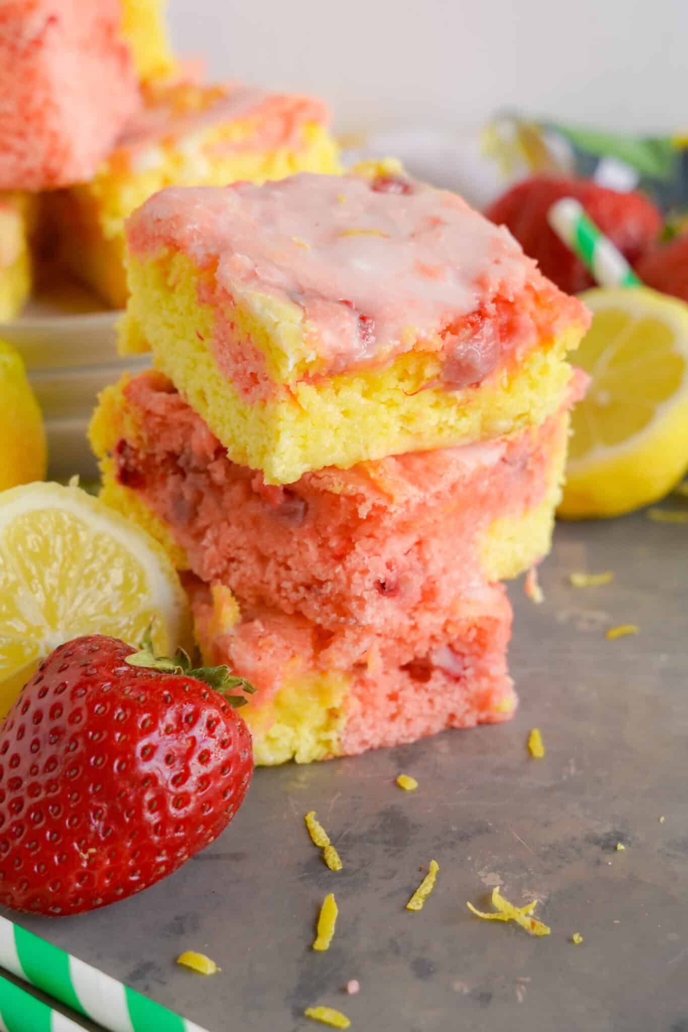 stack of three strawberry Lemon Blondies with a strawberry and sliced lemon next to them